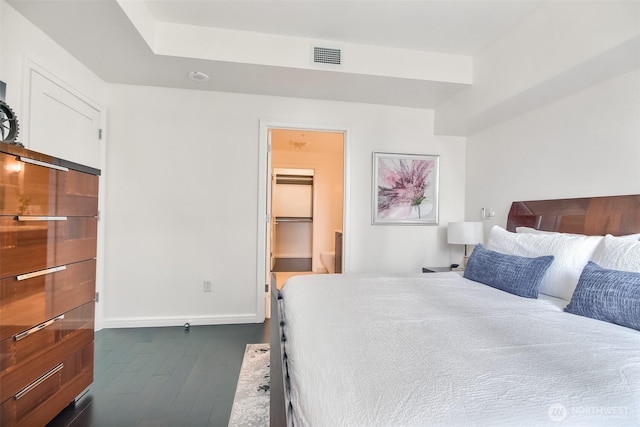10700 NE 4th St Unit 1006, Bellevue, WA 98004 - bedroom featuring dark wood finished floors, baseboards, and connected bathroom