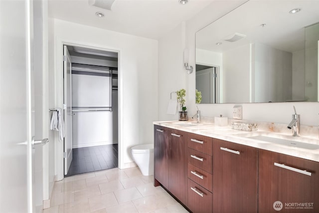 10700 NE 4th St Unit 1006, Bellevue, WA 98004 - full bath with toilet, double vanity, tile patterned floors, and baseboards