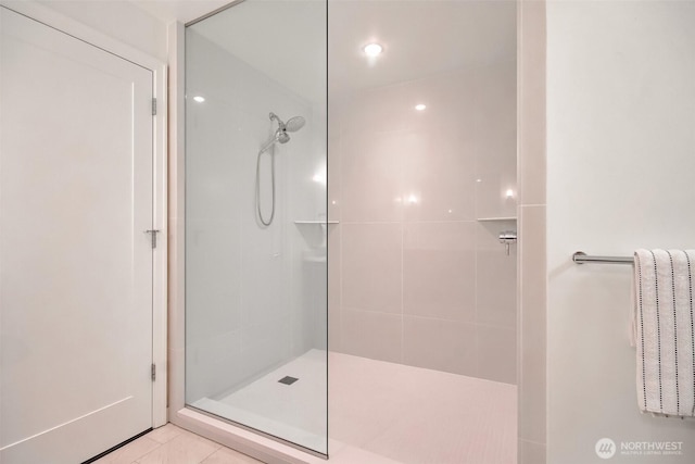 10700 NE 4th St Unit 1006, Bellevue, WA 98004 - bathroom featuring tiled shower and tile patterned flooring