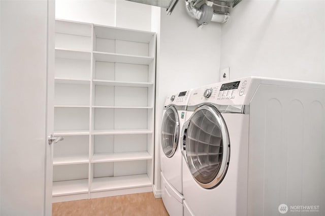 10700 NE 4th St Unit 1006, Bellevue, WA 98004 - washroom featuring washing machine and dryer