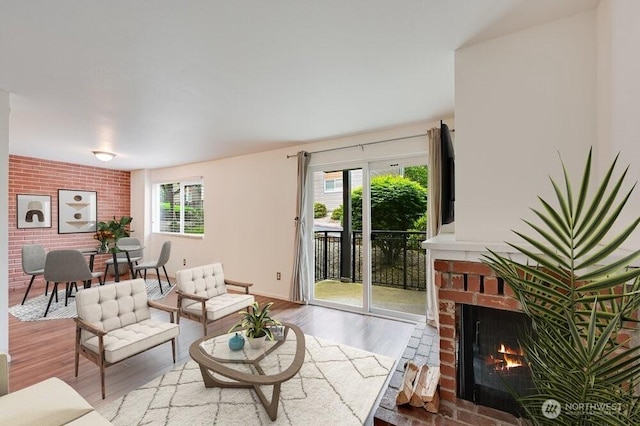 220 SW Clark St Unit B101, Issaquah, WA 98027 - living area with a brick fireplace, healthy amount of natural light, wood finished floors, and baseboards