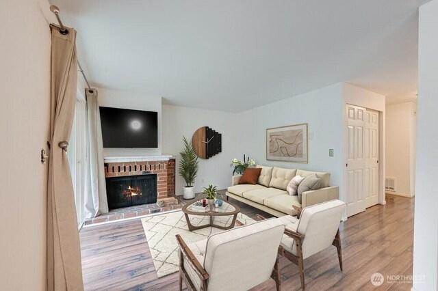 220 SW Clark St Unit B101, Issaquah, WA 98027 - living area with wood finished floors and a brick fireplace