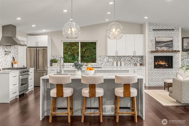 7429 NE 129th St, Kirkland, WA 98034 - kitchen with extractor fan, high quality appliances, vaulted ceiling, a sink, and decorative backsplash