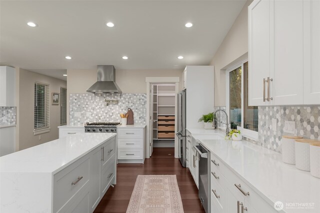 7429 NE 129th St, Kirkland, WA 98034 - kitchen with wall chimney range hood, stainless steel appliances, tasteful backsplash, and recessed lighting