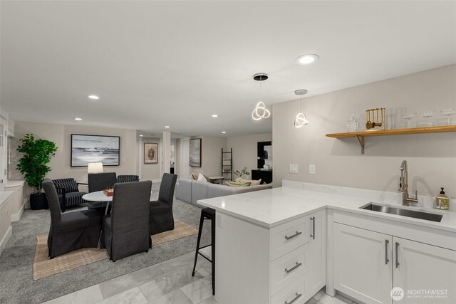 7429 NE 129th St, Kirkland, WA 98034 - kitchen featuring a sink, open floor plan, white cabinets, a breakfast bar, and recessed lighting