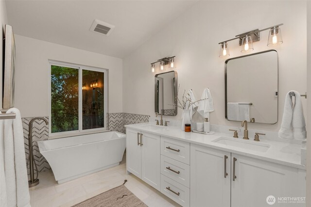 7429 NE 129th St, Kirkland, WA 98034 - full bath featuring double vanity, a soaking tub, marble finish floors, and tile walls