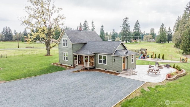 2217 200th St NE, Arlington, WA 98223 - view of front of property featuring driveway, a patio, and a shingled roof