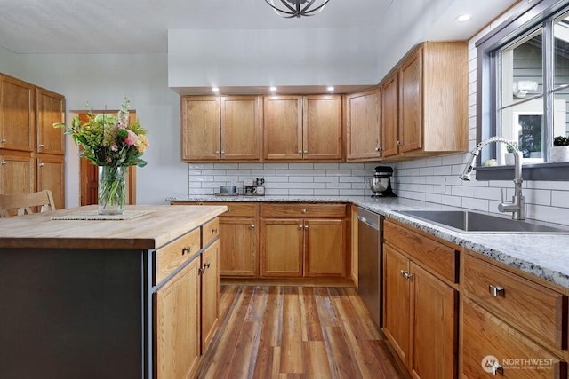 2217 200th St NE, Arlington, WA 98223 - kitchen with wood counters, stainless steel dishwasher, a sink, light wood-style floors, and backsplash