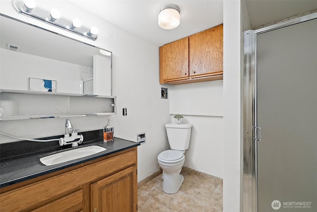 full bathroom featuring toilet, a shower with shower door, vanity, baseboards, and tile patterned flooring
