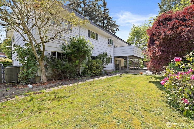 view of green lawn with central AC