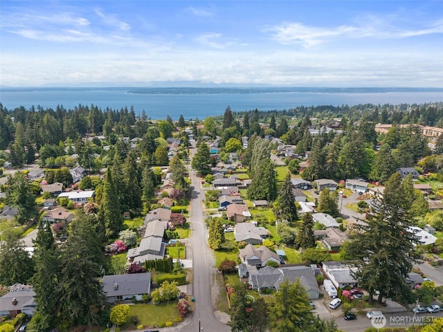 aerial overview of property's location with nearby suburban area and a nearby body of water