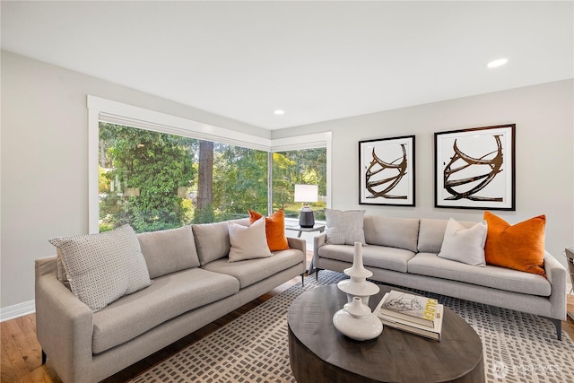 living area with light wood finished floors, recessed lighting, and baseboards