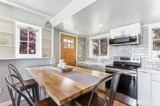 232 N Sunset Dr, Camano Island, WA 98282 - kitchen with appliances with stainless steel finishes, white cabinetry, light countertops, and decorative backsplash