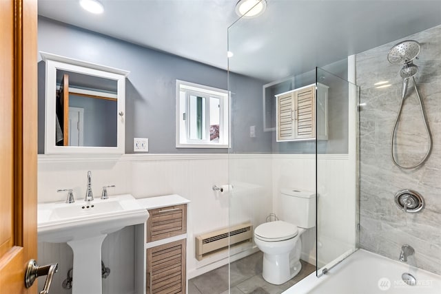 232 N Sunset Dr, Camano Island, WA 98282 - full bath featuring a baseboard radiator, toilet, shower / tub combination, a wainscoted wall, and tile patterned flooring