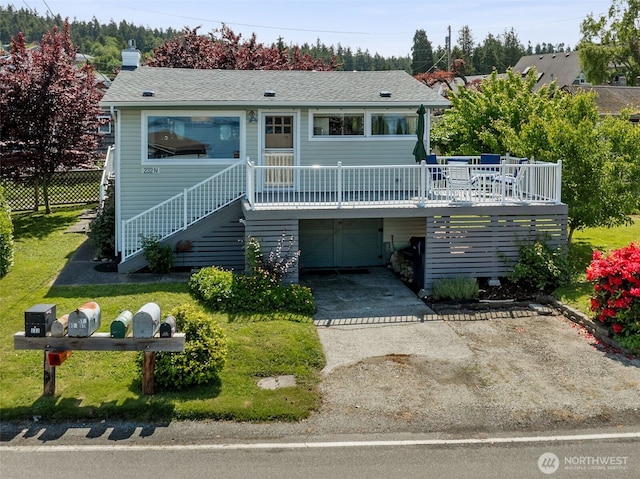 232 N Sunset Dr, Camano Island, WA 98282 - view of front of home with stairs, driveway, a wooden deck, a garage, and a shingled roof