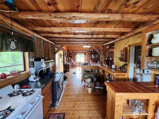 266 Bluebell Ln, Tonasket, WA 98855 - kitchen featuring gas range gas stove, wooden ceiling with exposed beams, light wood-type flooring, wooden walls, and open shelves