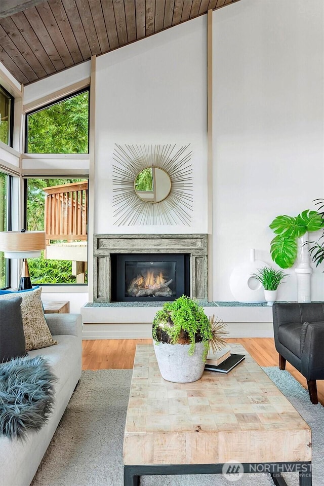 9340 Mercerwood Dr, Mercer Island, WA 98040 - living area featuring a glass covered fireplace, wood ceiling, wood finished floors, vaulted ceiling, and baseboards