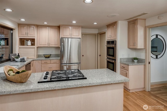 9340 Mercerwood Dr, Mercer Island, WA 98040 - kitchen with appliances with stainless steel finishes, light brown cabinetry, light wood-style flooring, light stone countertops, and recessed lighting