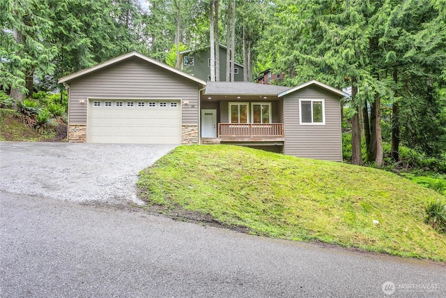 26 Inglewood Pl, Bellingham, WA 98229 - view of front of property with driveway, a garage, a porch, and stone siding