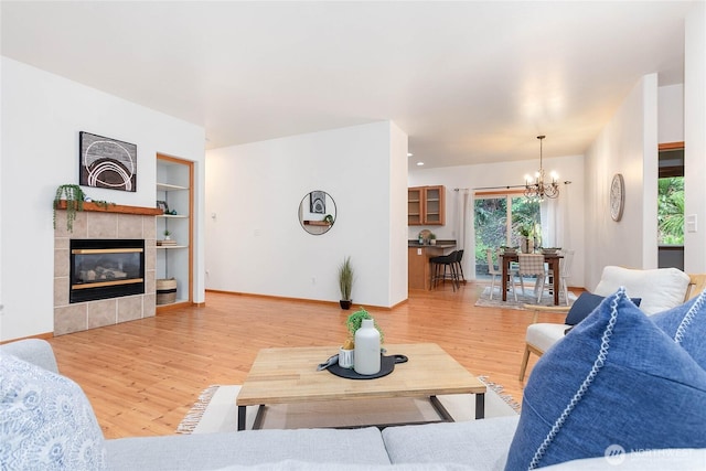 26 Inglewood Pl, Bellingham, WA 98229 - living room with light wood-style floors, built in features, a chandelier, and baseboards