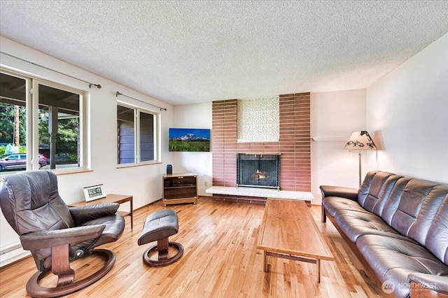 21918 83rd Ave W, Edmonds, WA 98026 - living area featuring a textured ceiling, wood finished floors, and a fireplace
