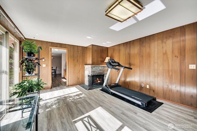 21918 83rd Ave W, Edmonds, WA 98026 - workout area with a fireplace with flush hearth, wood finished floors, wood walls, and a skylight