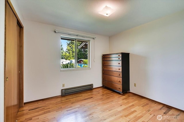 21918 83rd Ave W, Edmonds, WA 98026 - unfurnished bedroom featuring light wood-style flooring, a baseboard heating unit, and a closet