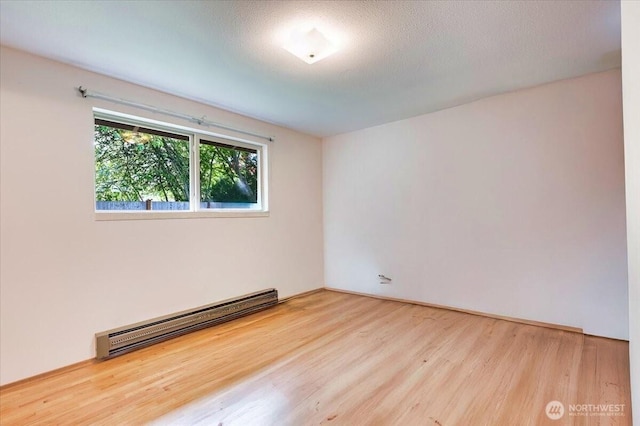 21918 83rd Ave W, Edmonds, WA 98026 - unfurnished room featuring a baseboard radiator and wood finished floors