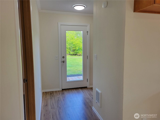 2917 Tierney St SW, Olympia, WA 98512 - doorway to outside featuring crown molding, wood finished floors, and baseboards