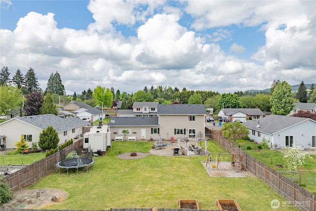 307 E Wilson St, Yacolt, WA 98675 - back of house featuring a residential view, a fire pit, a trampoline, and a patio