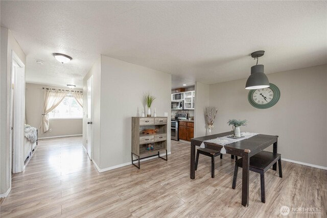 307 E Wilson St, Yacolt, WA 98675 - dining space featuring light wood finished floors, baseboards, and a textured ceiling