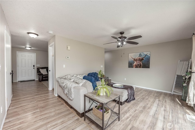 307 E Wilson St, Yacolt, WA 98675 - living room featuring light wood-type flooring, a ceiling fan, and baseboards