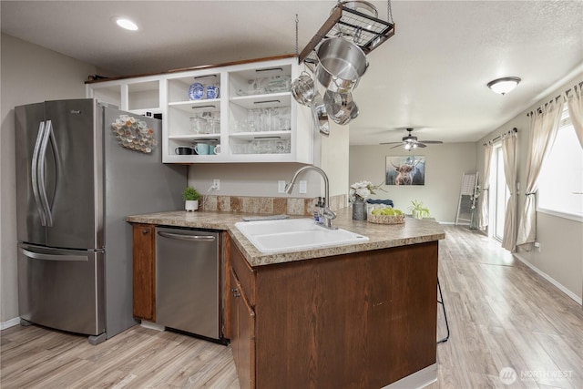 307 E Wilson St, Yacolt, WA 98675 - kitchen featuring appliances with stainless steel finishes, a sink, light wood-type flooring, and ceiling fan