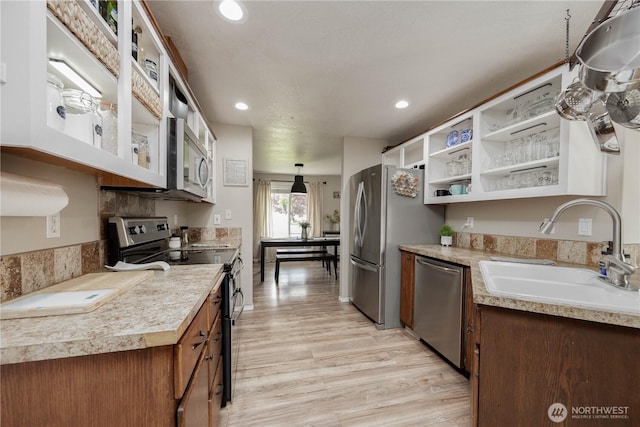 307 E Wilson St, Yacolt, WA 98675 - kitchen with appliances with stainless steel finishes, a sink, light wood-type flooring, light countertops, and open shelves