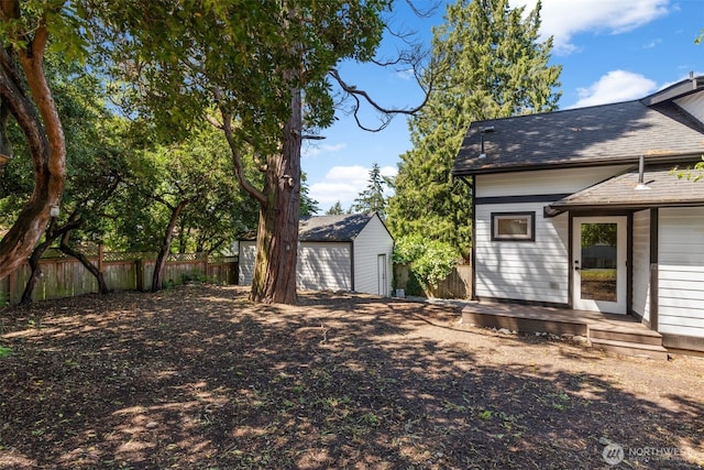2125 N 90th St, Seattle, WA 98103 - view of yard with a detached garage and an outbuilding