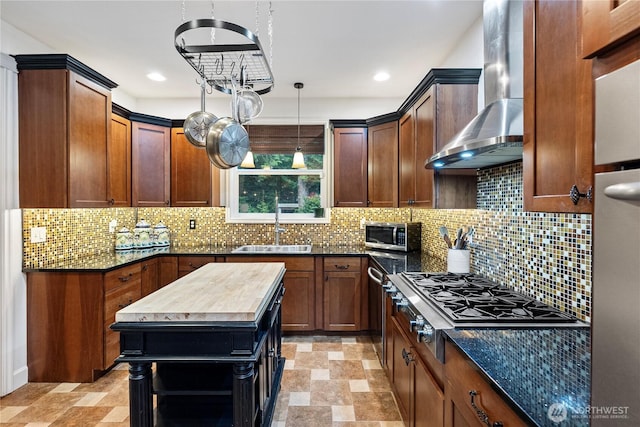 4565 Harper Hill Rd SE, Port Orchard, WA 98366 - kitchen with wall chimney range hood, appliances with stainless steel finishes, recessed lighting, stone finish floors, and decorative backsplash
