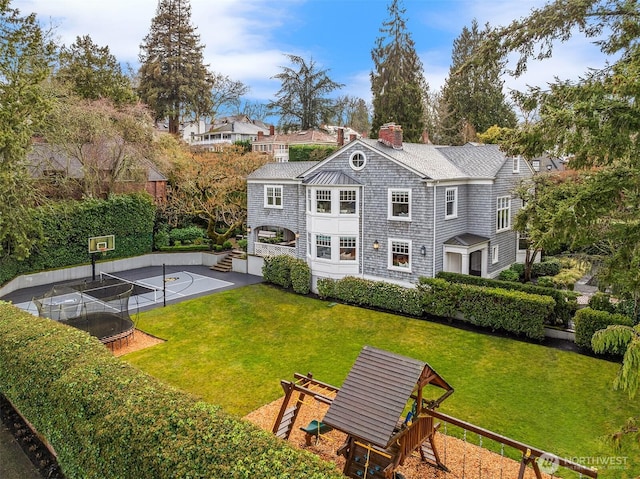 3719 E Highland Dr, Seattle, WA 98112 - back of house with a trampoline, a chimney, a yard, and a playground