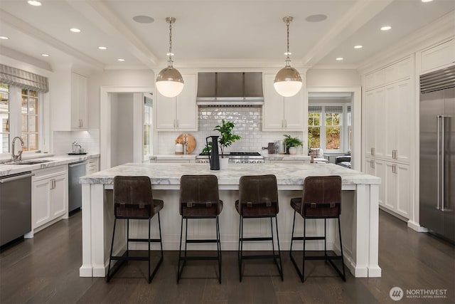 3719 E Highland Dr, Seattle, WA 98112 - kitchen featuring a sink, wall chimney exhaust hood, appliances with stainless steel finishes, white cabinetry, and recessed lighting