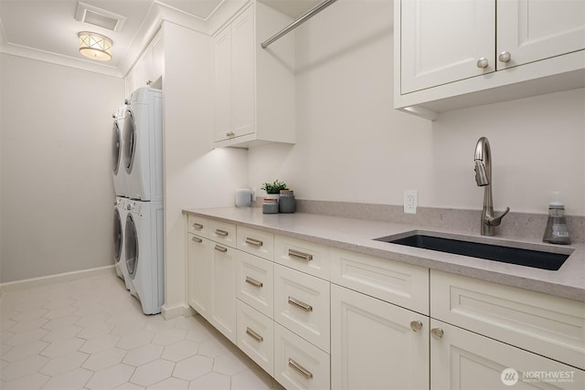 3719 E Highland Dr, Seattle, WA 98112 - washroom with stacked washing machine and dryer, cabinet space, and baseboards