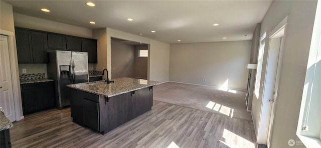 2826 Anna St NE, Lacey, WA 98502 - kitchen with stainless steel fridge with ice dispenser, light wood-type flooring, a sink, recessed lighting, and light stone counters