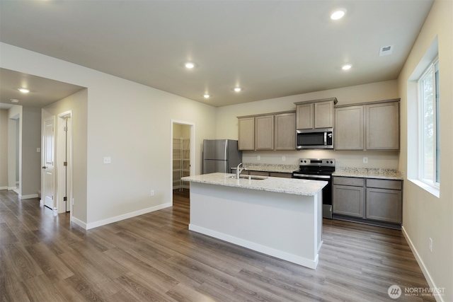 8507 13th Ave E, Tacoma, WA 98445 - kitchen with appliances with stainless steel finishes, a sink, a kitchen island with sink, dark wood finished floors, and recessed lighting
