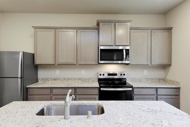 8507 13th Ave E, Tacoma, WA 98445 - kitchen featuring stainless steel appliances, a sink, and light stone counters