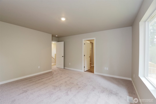 8507 13th Ave E, Tacoma, WA 98445 - unfurnished room featuring light carpet and baseboards