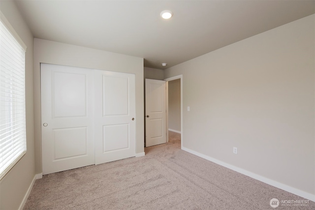 8507 13th Ave E, Tacoma, WA 98445 - unfurnished bedroom with carpet flooring, baseboards, and a closet
