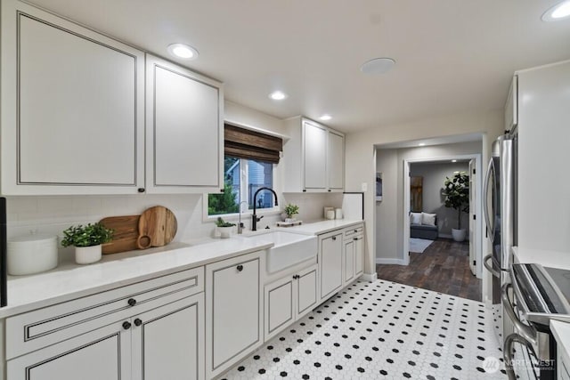 10220 NE Lafayette Ave, Bainbridge Island, WA 98110 - kitchen featuring a sink, appliances with stainless steel finishes, backsplash, light countertops, and recessed lighting