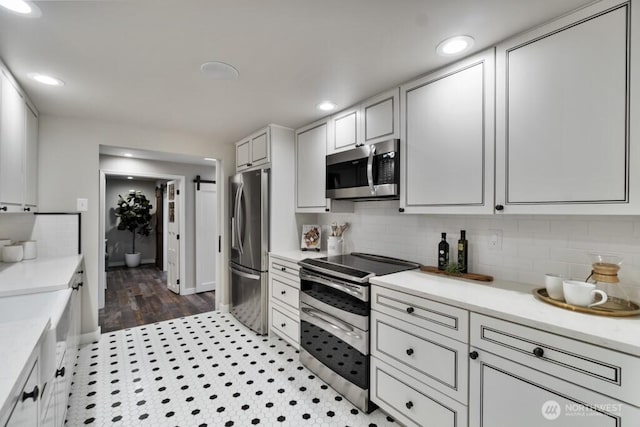 10220 NE Lafayette Ave, Bainbridge Island, WA 98110 - kitchen featuring stainless steel appliances, light countertops, backsplash, recessed lighting, and white cabinetry