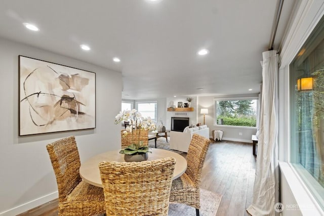 10220 NE Lafayette Ave, Bainbridge Island, WA 98110 - dining room featuring hardwood / wood-style flooring, baseboards, a fireplace, and recessed lighting