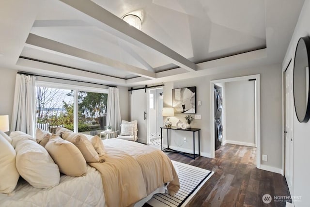 10220 NE Lafayette Ave, Bainbridge Island, WA 98110 - bedroom with estacked washer and dryer, a raised ceiling, dark wood-style flooring, and baseboards
