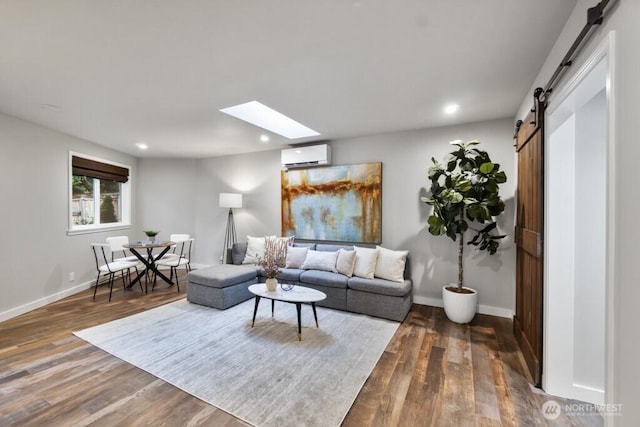 10220 NE Lafayette Ave, Bainbridge Island, WA 98110 - living room with a wall unit AC, a barn door, wood finished floors, a skylight, and recessed lighting