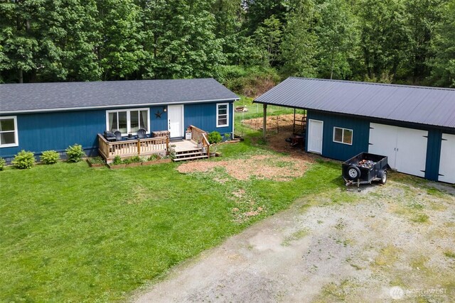 1707 Bonnie Ln, Camano Island, WA 98282 - view of front facade featuring a front yard, an outbuilding, and a deck